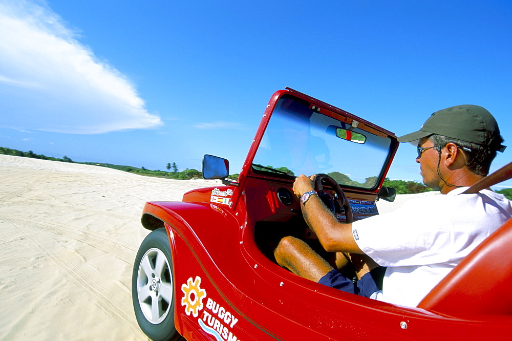 Driving dune buggy on sand dunes, Pitangui, Natal, Rio Grande do Norte state, Brazil, South America