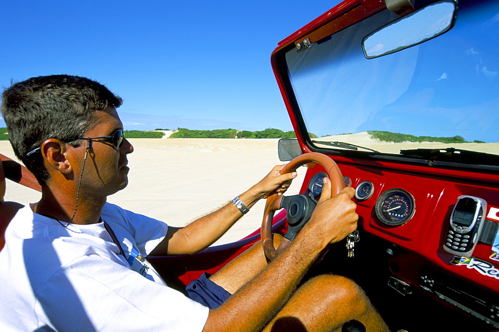 Driving dune buggy on sand dunes, Pitangui, Natal, Rio Grande do Norte state, Brazil, South America