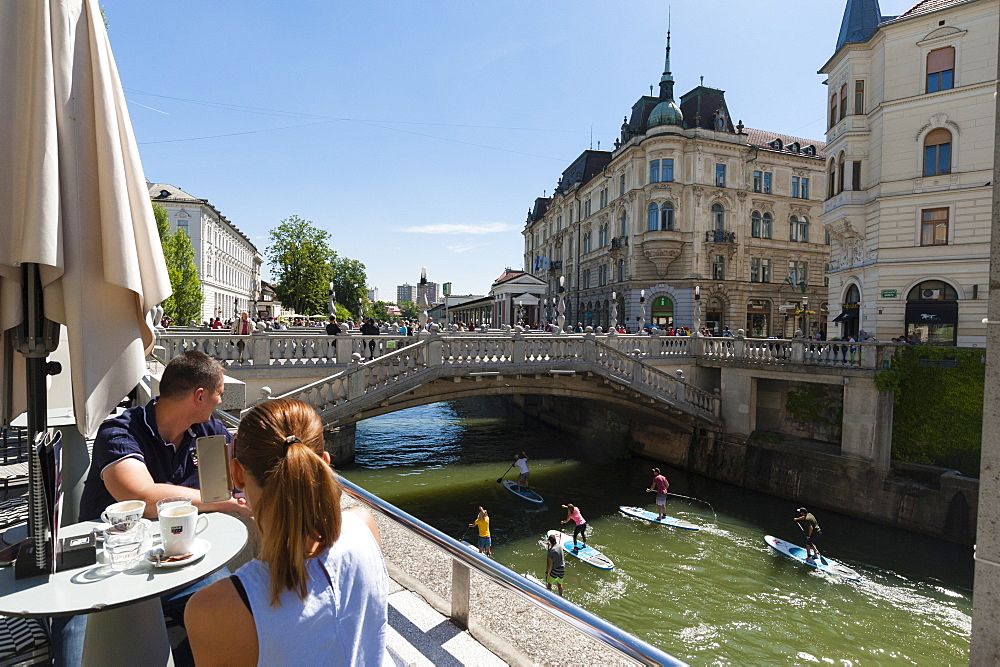 A bar overlooking the Triple Bridge over the Ljubljanica River, Ljubljana, Slovenia, Europe