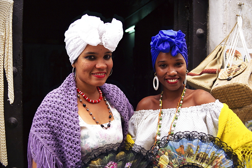 Young women in typical Cuban dress holding fans, Habana Vieja, Havana, Cuba, West Indies, Central America