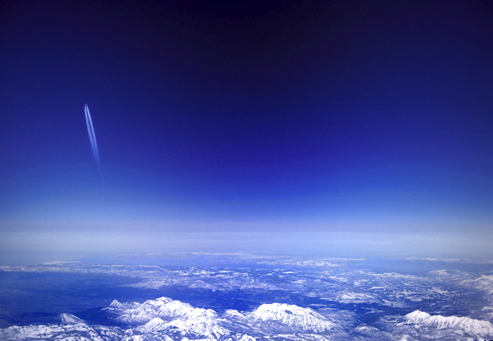 Aircraft vapour trails above clouds over Colorado, United States of America, North America