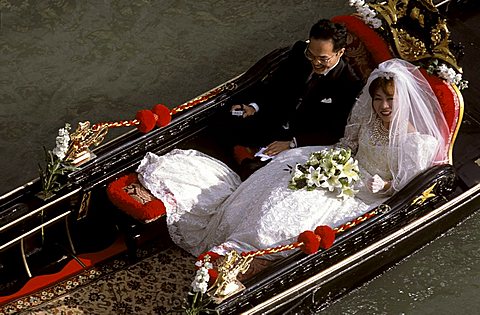 Newlywed couple on gondola, Venice, Veneto, Italy