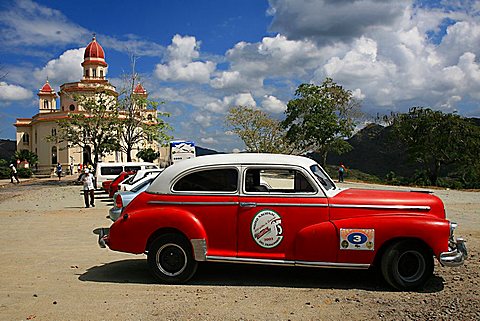 Vintage car in front of Virgen de la Caridad del Cobre sanctuary, Santiago de Cuba, Cuba, West Indies, Central America