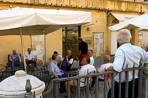 People relaxing, Piazza del Duomo, Pietrasanta, Tuscany, Italy