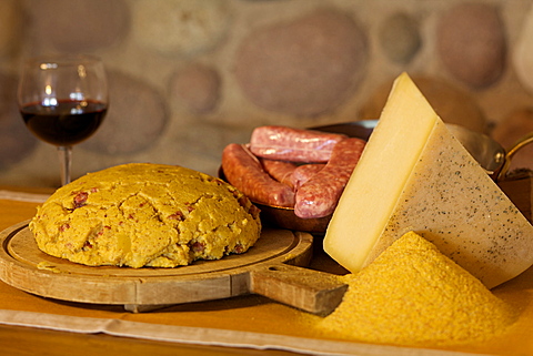 Polenta carbonera and his ingredients vith Spressa cheese, sausage and flour, Giudicarie valley, Trentino, Italy, Europe