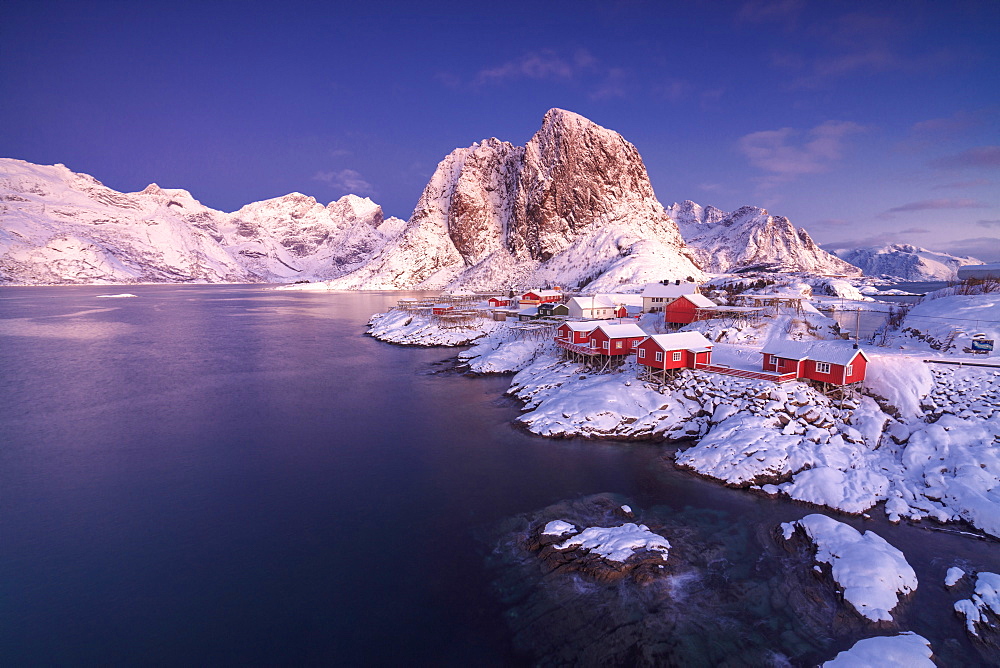 The colors of dawn on snowy peaks and the frozen sea around the fishing village Hamnoy Nordland, Lofoten Islands, Norway, Europe