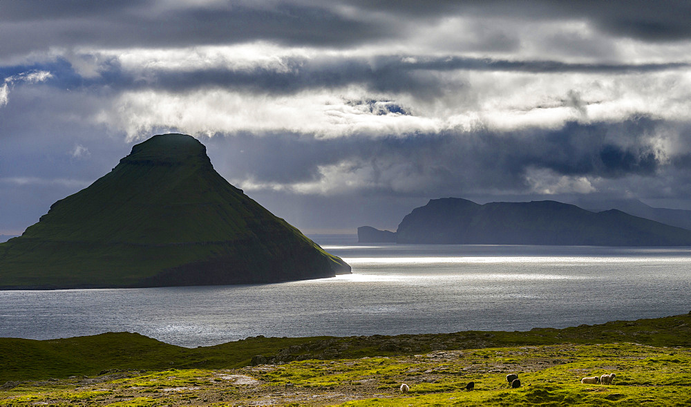 Koltur island at sunset, the island Vagar in the background The island Streymoy, one of the two large islands of the Faroe Islands  in the North Atlantic.  Europe, Northern Europe, Denmark, Faroe Islands