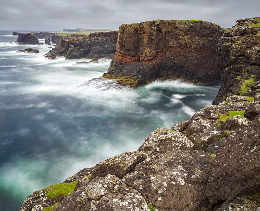 Landscape on the Eshaness peninsula. The famous cliffs and sea stacks of Eshness, a major attraction on the Shetland Islands. the cliffs are a major part of the Geopark Shetland, showing a cross section of a 395 mio years old vulcano  europe, central europe, northern europe, united kingdom, great britain, scotland, northern isles,shetland islands, june