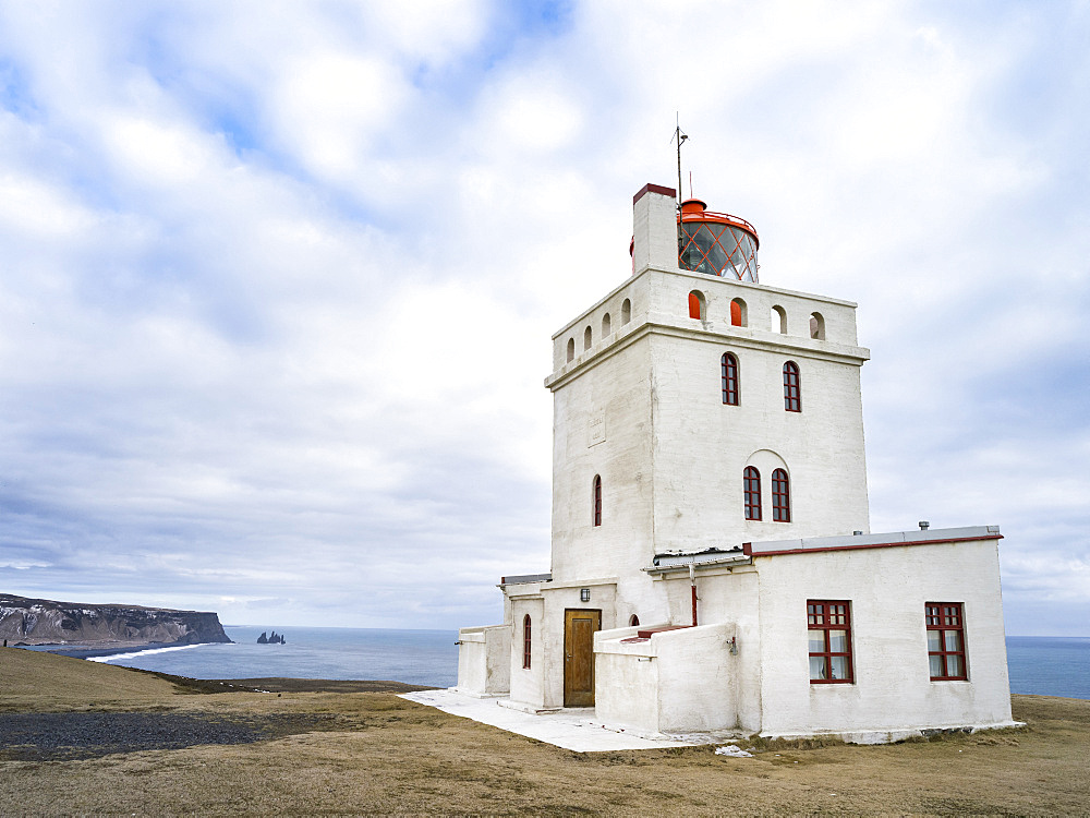 Coast of the North Atlantic near Vik y Myrdal during winter, the lighthouse at cape Dyrholaey. europe, northern europe, scandinavia, iceland,  February