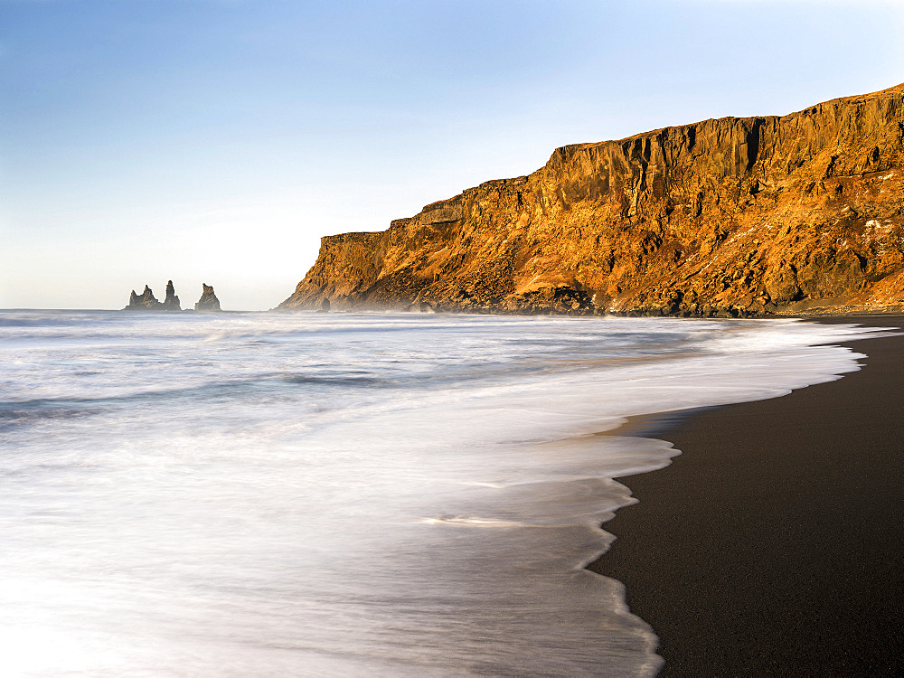 Coast of the North Atlantic near Vik y Myrdal during winter. Beach during sunrise with the sea stacks called Reynisdrangar. europe, northern europe, scandinavia, iceland,  February