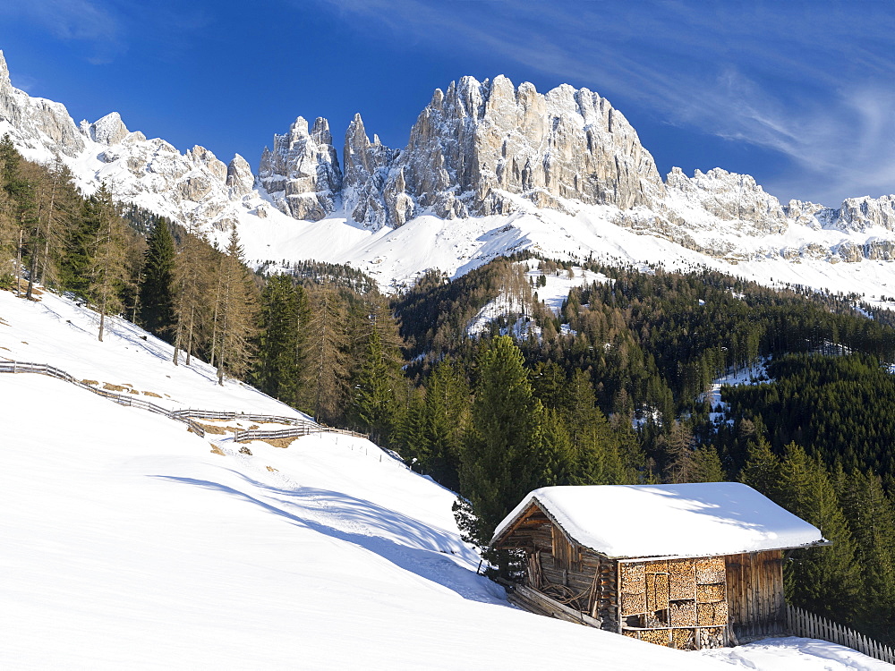 Rosengarten also called Catinaccio mountain range in the Dolomites of South Tyrol (Alto Adige) in winter and deep snow. The peaks Tschamin Spitzen, the Vajolet Towers and the Laurin Wand.  The Rosengarten is part of the UNESCO world heritage site Dolomites. Europe, Central Europe, Italy, South Tyrol, March