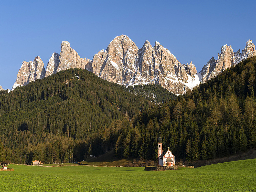 The peaks of the GEisler mountain range in valley Villnoess.  The church Sankt Johann in Ranui (St. John in Ranui). The Geisler mountain range is one of the most famous areas for hikers and climbers in the Dolomites. This part of the dolomites is part of the nature park Puez-Geisler and belongs to the UNESCO world heritage Dolomites.  Europe, Central Europe, Italy, South Tyrol, April 2012