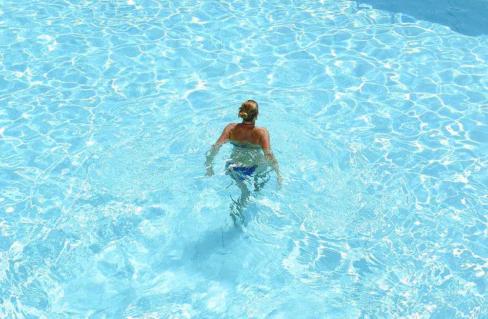 Woman swimming in the Hotel pool, Hotel la Baja, Santa Caterinia di Pittinuri, Sardinia, Italy, Europe