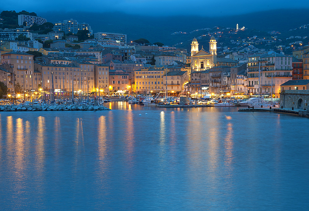 Marina in front of the church Eglise Saint Jean Baptiste at dusk, Corsica, France, Europe