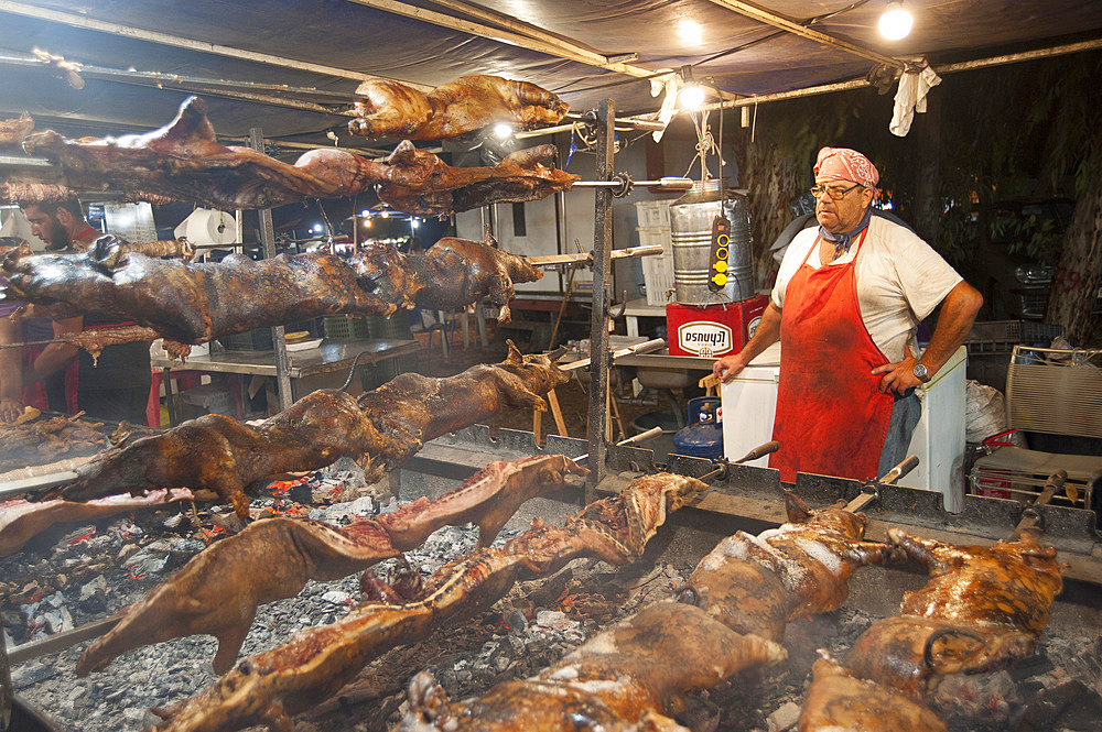 Porceddu, roast baby pork wrapped around a spit, typical Sardinia recipe, Campidano, Sardinia, Italy, Europe