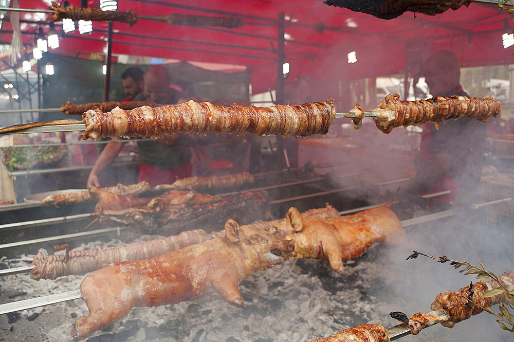 Porceddu, roast baby pork wrapped around a spit, Cordula made up of braided and cooked kid or lamb intestines wrapped around a spit, typical Sardinia recipe, Campidano, Sardinia, Italy, Europe