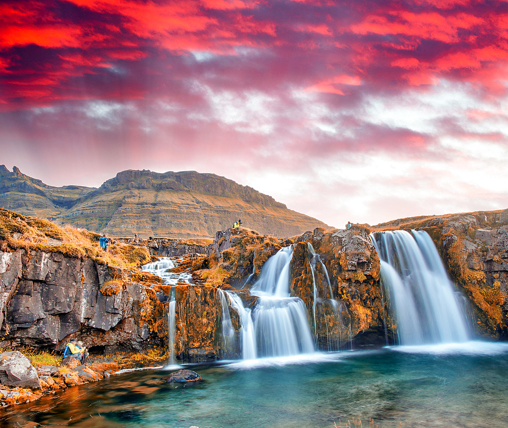 Famous travel location in Iceland. Kirkjufell Waterfalls at sunset, long exposure at sunset