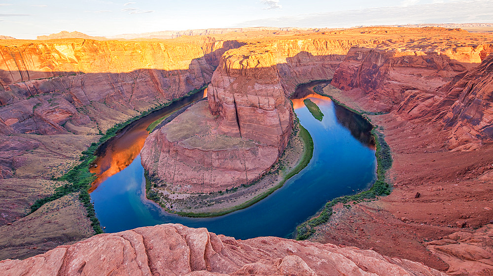 Dawn at Horseshoe Bend. Sunrise colors with Rocks and Colorado River.