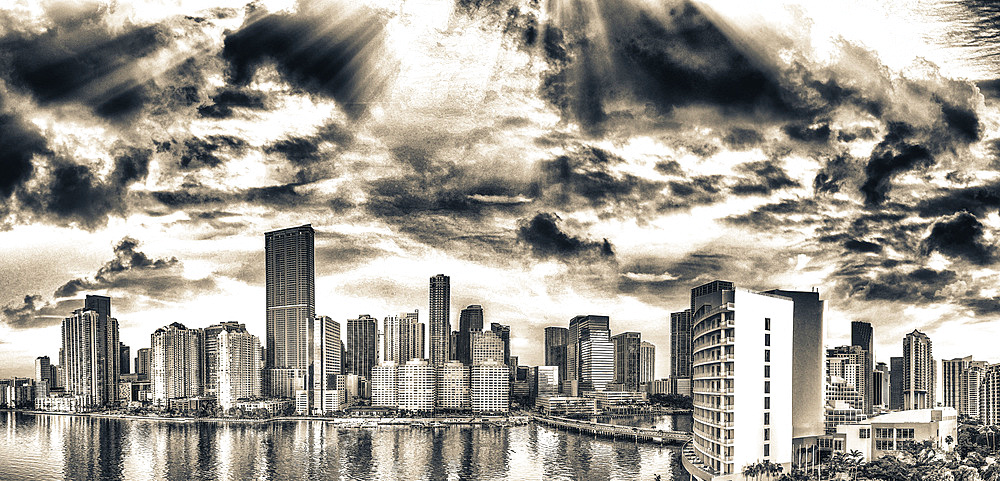 Panoramic aerial view of Downtown Miami and Brickell Key at sunrise.