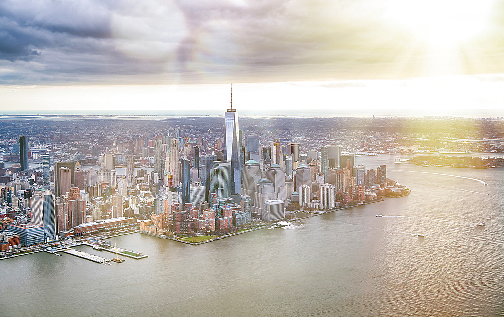 New York City from helicopter point of view. Downtown Manhattan, Jersey City and Hudson River on a cloudy day.