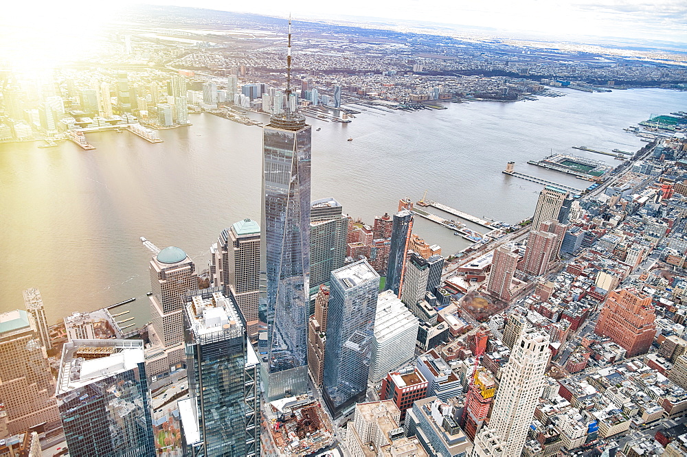 New York City from helicopter point of view. Downtown Manhattan skyscrapers on a cloudy day.