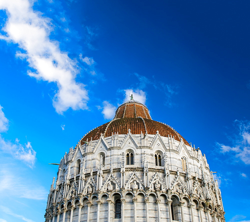 Pisa, Italy. Baptistery against the sky in famous Square of Miracles.