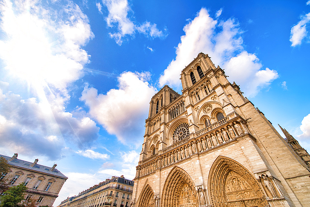 Notre Dame majestic facade against a beautiful blue sky, Paris