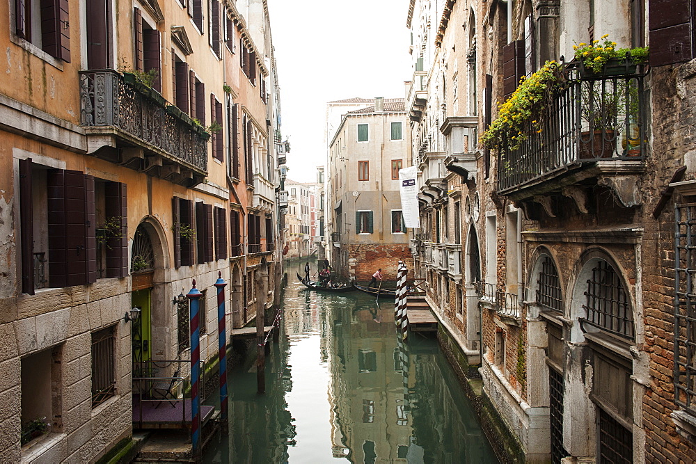 A view over the canal, In the distance you can see two gondolas, a typical boat used in Venice to wade channels led by a sailor, Veneto, Italy, Europe