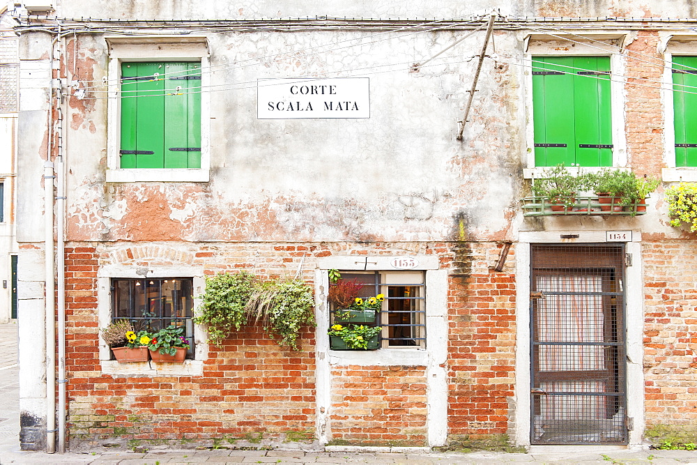 The front of an old house in Corte Scala Mata square, Cannaregio sestiere, not far from the Jewish ghetto in Venice, Veneto, Italy, Europe