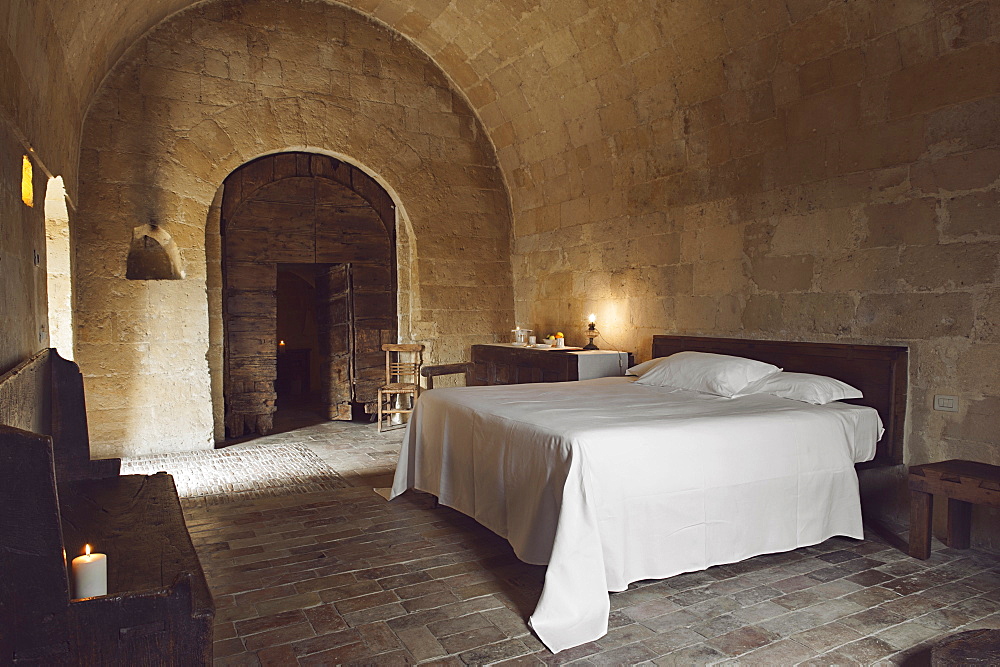 Bedroom of the hotel Le Grotte della Civita located in the Sassi di Matera that represents the almost paradigmatic expression of the Minor Historical Heritage, Matera, Basilicata, Italy, Europe