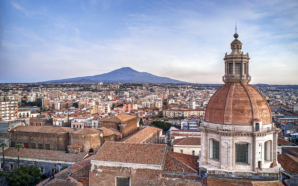 Aerial view of the dome and roofs of the Benedictine Monastery and in the background the Etna Volcano, Catania, Sicily, Italy, Europe