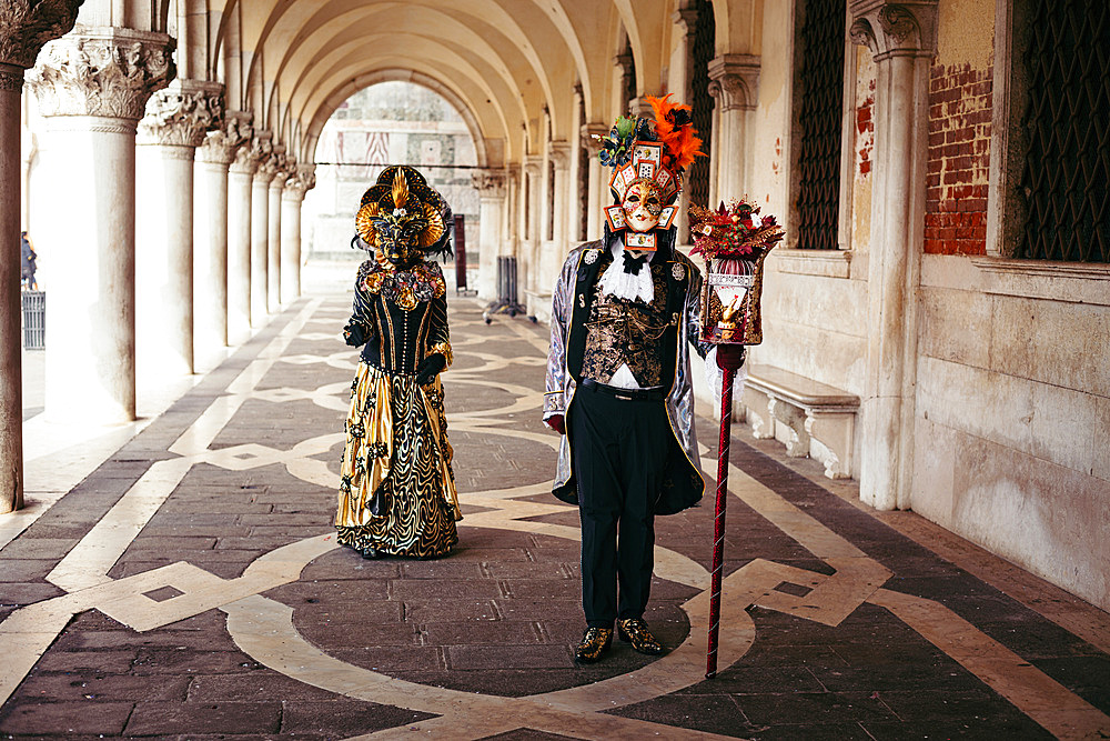 Portrait of a couple with beautiful masks in Venice, Veneto, Italy, Europe