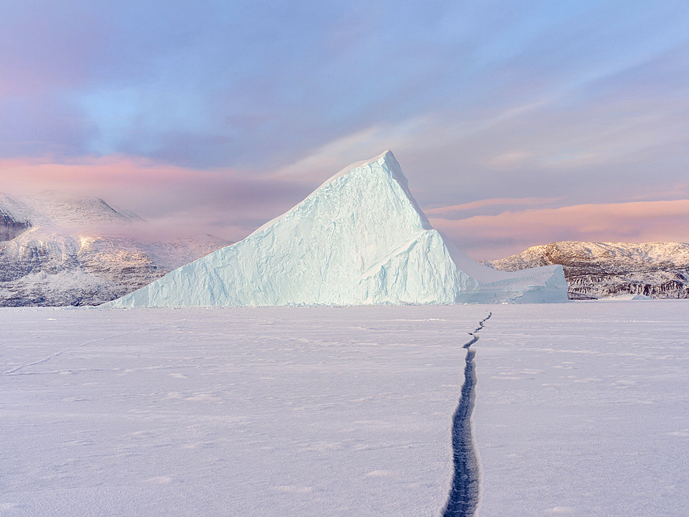 Icebergs in front of Stoeren Island, frozen into the sea ice of the Uummannaq fjord system during winter in the the north west of Greenland, far beyond the polar circle. North America, Greenland, danish territory