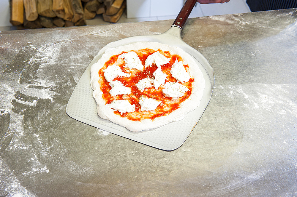 The preparation of a classic Margherita pizza, Italy, Step 11