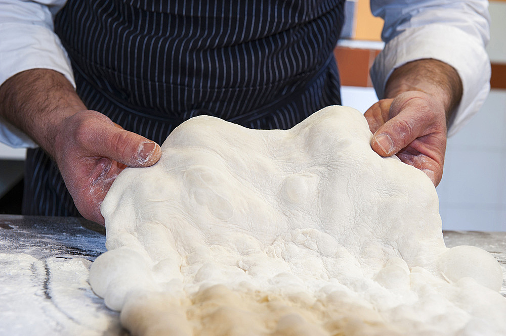 The preparation of a classic focaccia. Italy