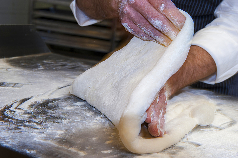 The preparation of a classic focaccia. Italy