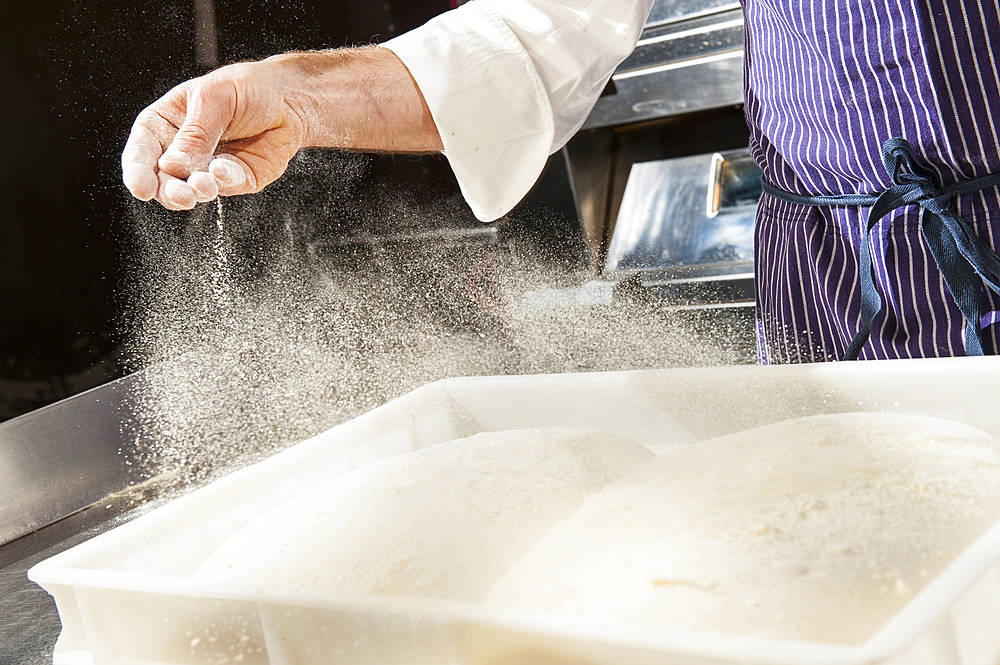 The preparation of a classic focaccia. Italy