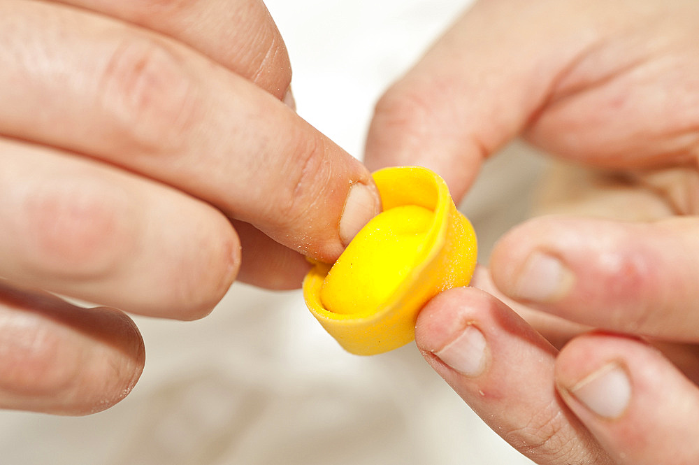 Preparing handmade fresh pasta Tortelli. Italy