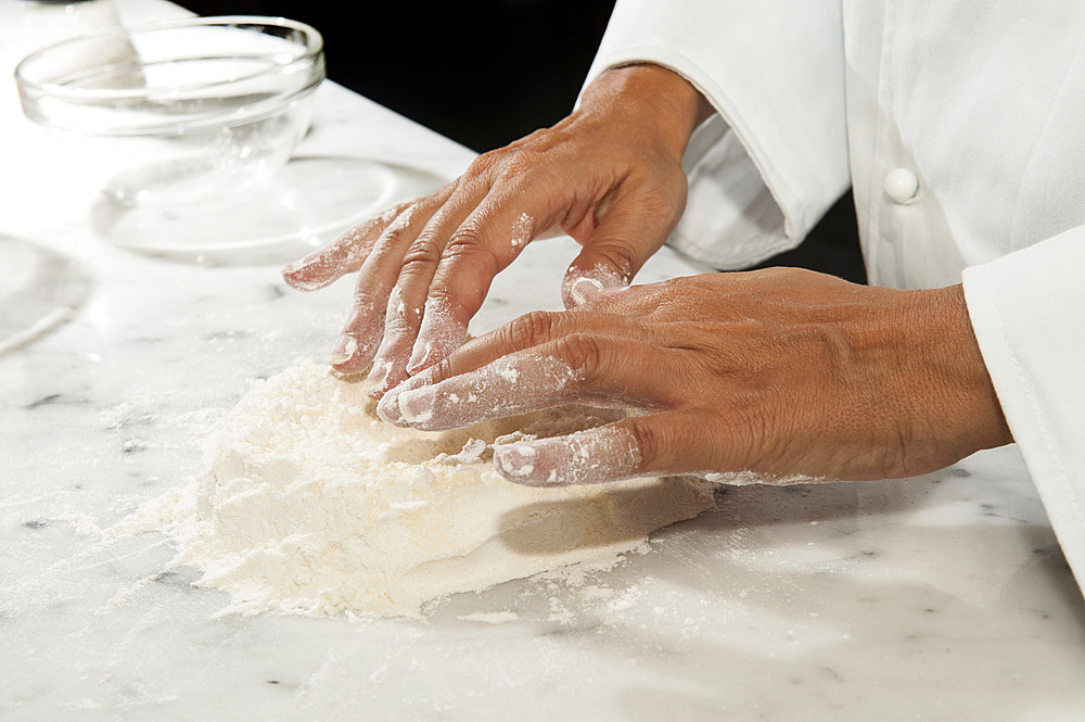 Working with fresh egg pasta by hand. Italy