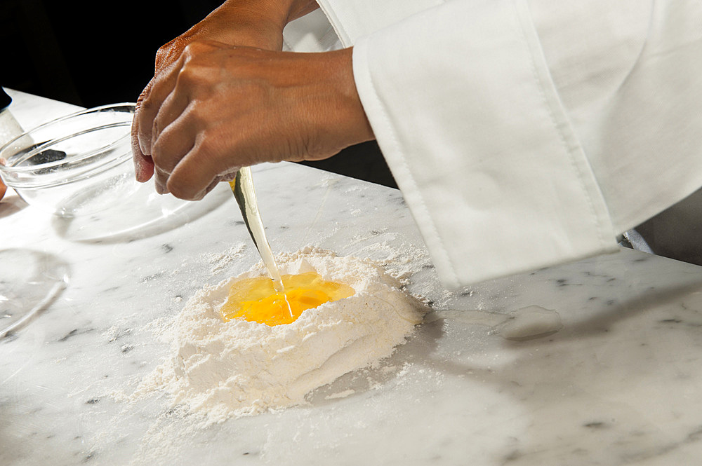 Working with fresh egg pasta by hand. Italy