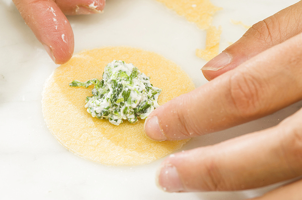 Making fresh tortelli by hand. Italy