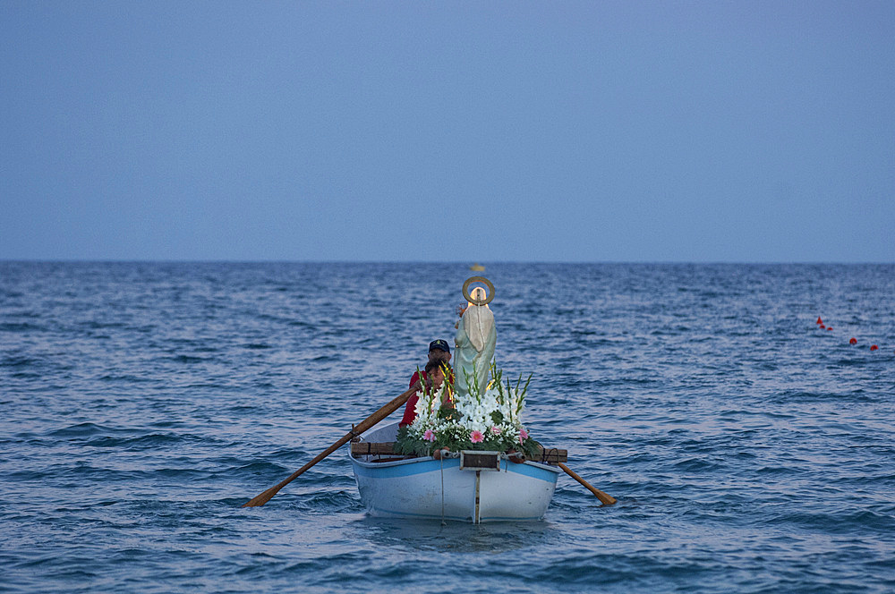 During the procession of the Madonna della Neve on 5 August the statue of the Madonna is taken by rowing boat to the Natarella beach. Savona; Liguria; Italy