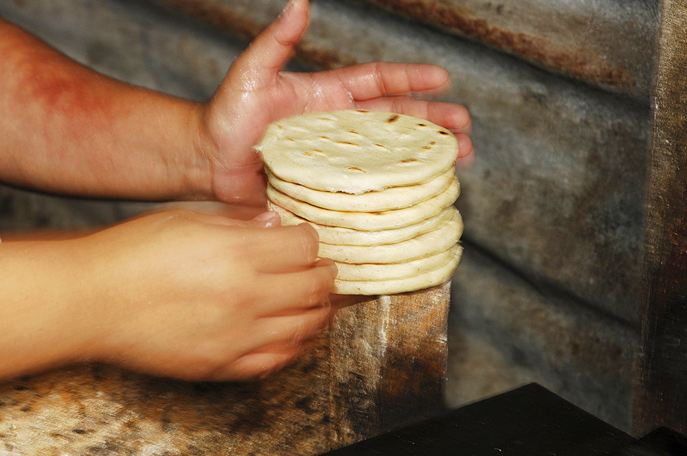 Processing of rice popusa at the Zacatecoluca market. El Salvador, Central America.