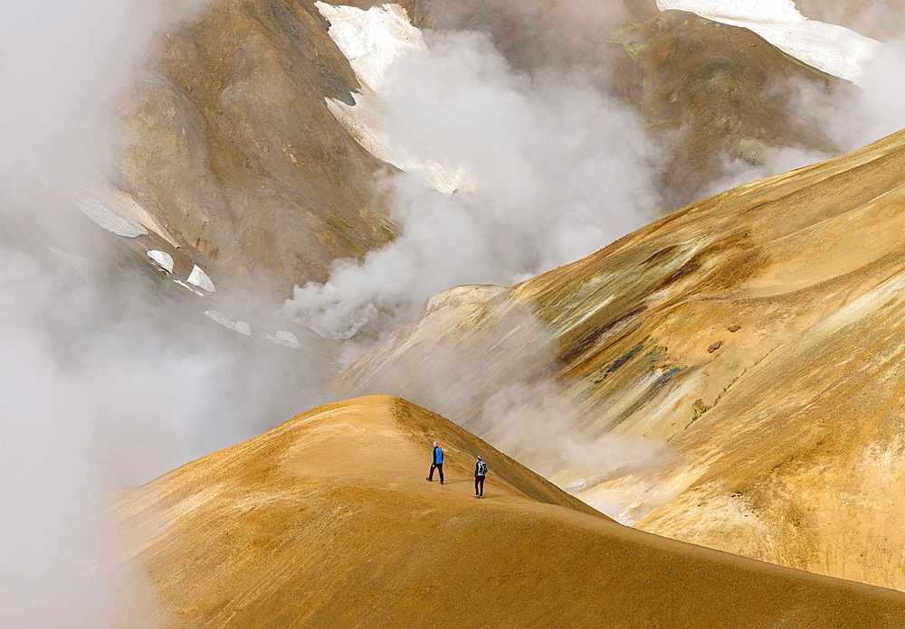 Hikers in the geothermal area Hveradalir in the mountains Kerlingarfjoell in the highlands of Iceland. Europe, Northern Europe, Iceland, August