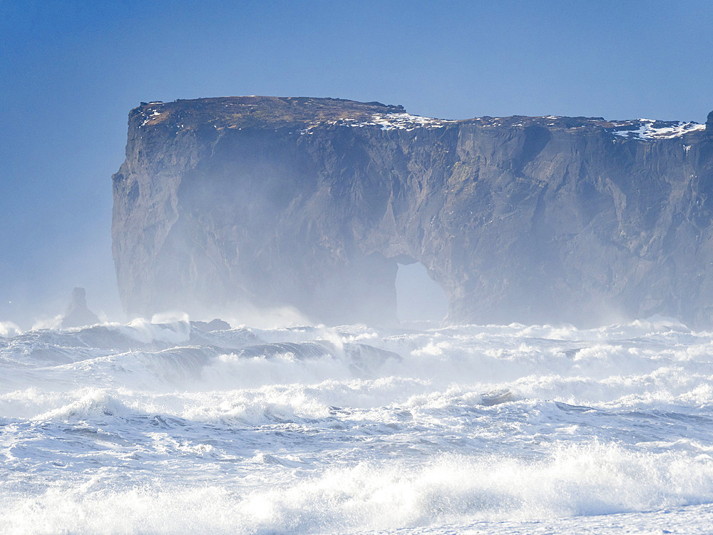 The coast of the north atlantic near Vik y Myrdal during winter. Black volcanic beach Reynisfjara, view towards Dyrholaey. Europe, Northern Europe, Scandinavia, Iceland, February