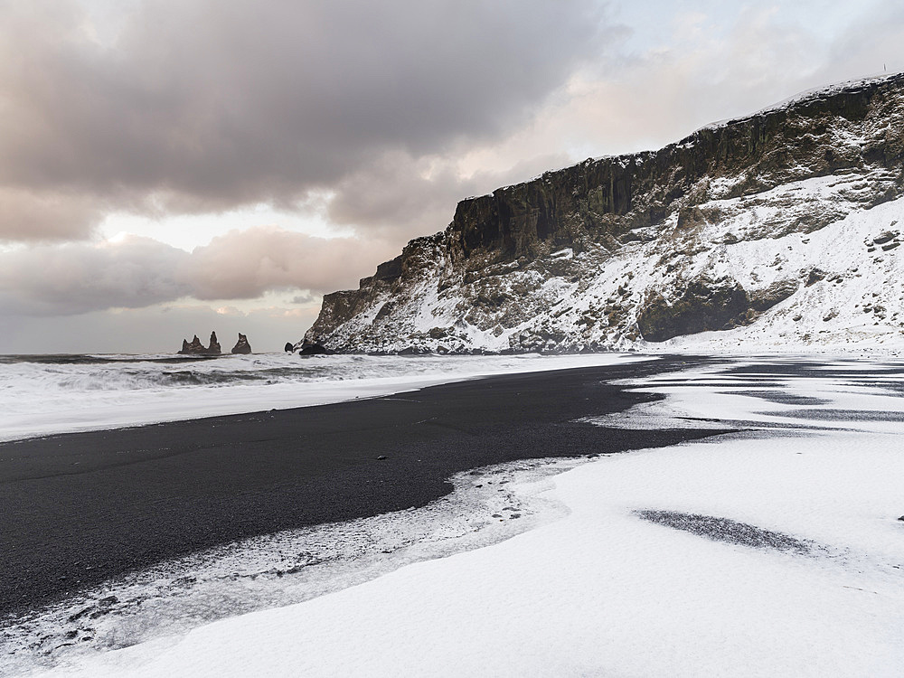 The coast of the north atlantic near Vik y Myrdal during winter. Black volcanic beach with the sea stacks Reynisdrangar. Europe, Northern Europe, Scandinavia, Iceland, February