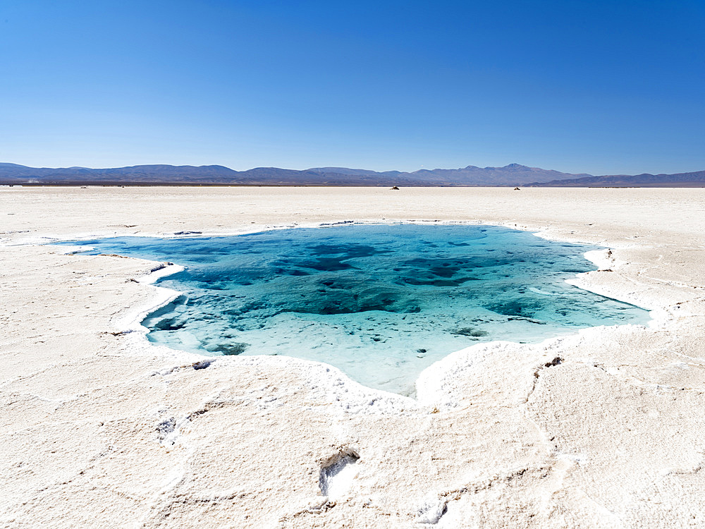 Ojos del Salar, groundwater ponds and surface of the Salar predominantly natriumchloride. Landscape on the salt flats Salar Salinas Grandes in the Altiplano. South America, Argentina