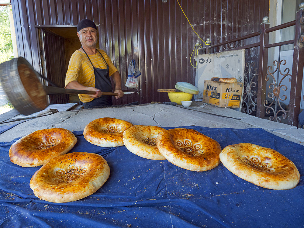 Typical, Traditional bakery making Lepjoschka bread in a clay oven. City Jalal-Abad (Dzhalal-Abad, Djalal-Abat, Jalalabat) in the Fergana Valley close to the border to Uzbekistan. Asia, central Asia, Kyrgyzstan