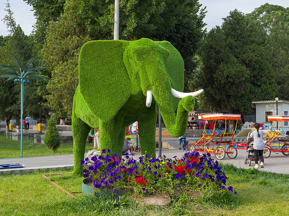 Wrong bush trimming, animals are made from plastic. The city park. City Jalal-Abad (Dzhalal-Abad, Djalal-Abat, Jalalabat) in the Fergana Valley close to the border to Uzbekistan. Asia, central Asia, Kyrgyzstan