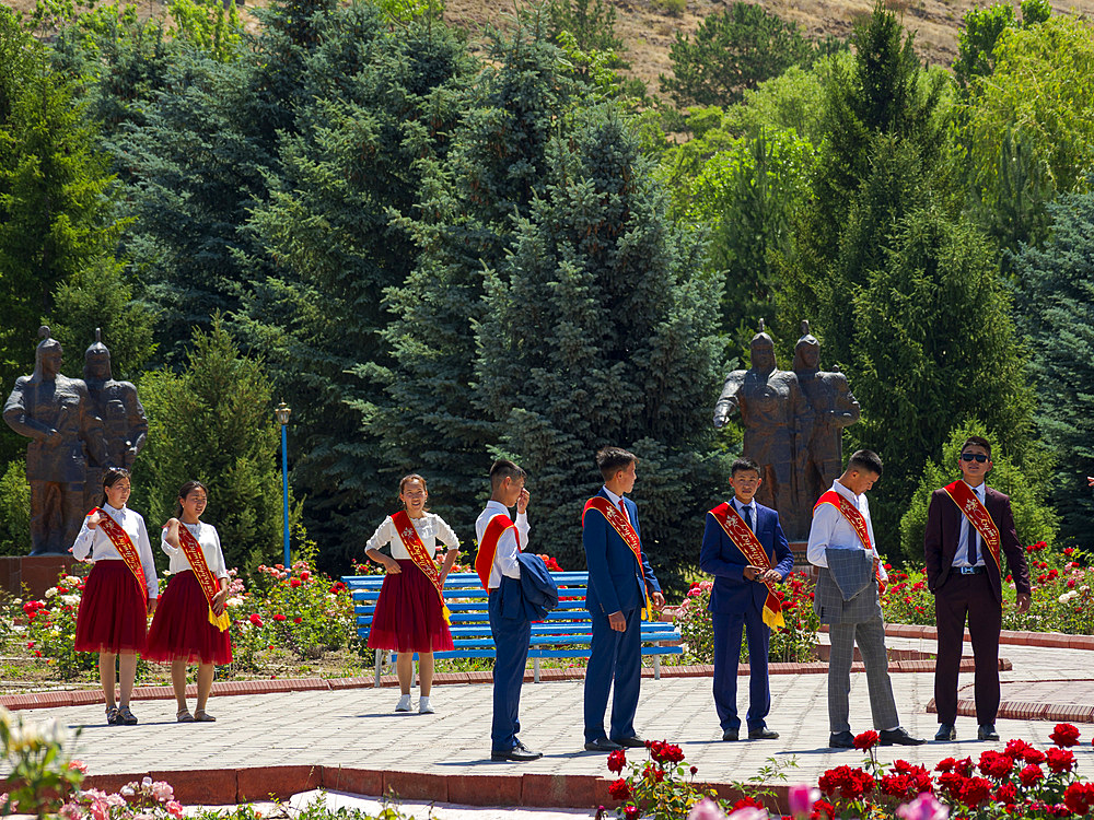 High school graduates are celebrating their graduation. Memorial Place Manas Ordo near Talas in the Tien Shan mountains. Manas, a mystical as well as a historic person is considered as the founding father of historic Kyrgyzstan. Asia, Central Asia, Kyrgyzstan